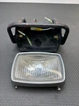 #1 1986-88 Polaris Trail Boss 250 Oem Headlight Lens Case Trim Ring Mount Guard. Fixed Price $49.80.